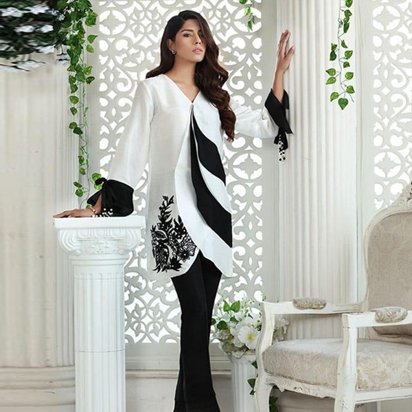 Elegant woman wearing a classic black and white dress showcasing timeless fashion appeal