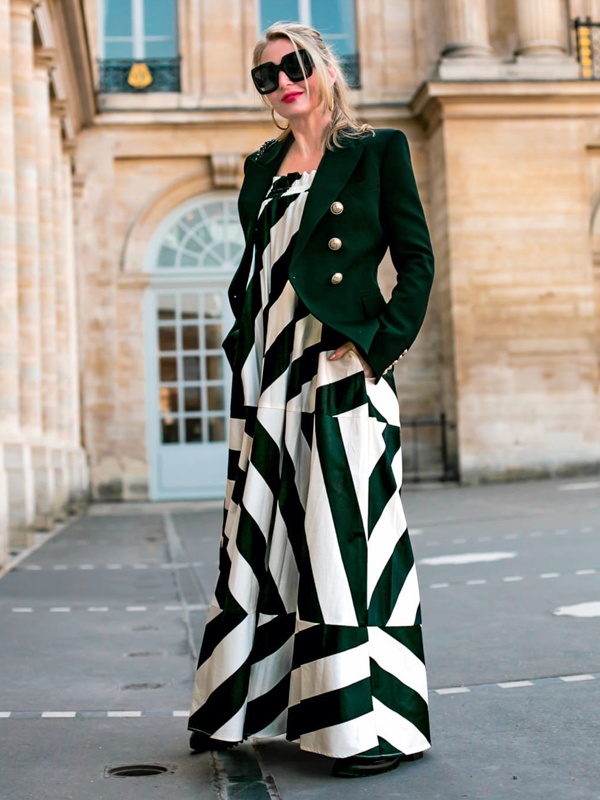 Street style black and white bold striped midi dress layered with classic black coat and sunglasses