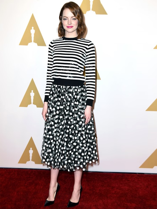 Emma Stone wearing Michael Kors black white striped sweater paired with grey polka dot midi skirt