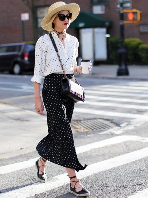 Stylish polka dot outfit with white blouse featuring black dots paired with black skirt with white dots