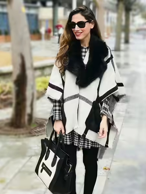 Winter black and white striped dress layered over black woolen leggings with fur scarf and tote bag