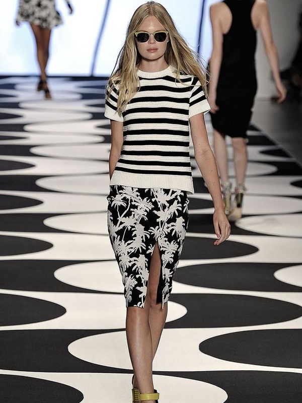 Pattern mixing outfit with black white striped tee and black floral print skirt with slit and yellow heels