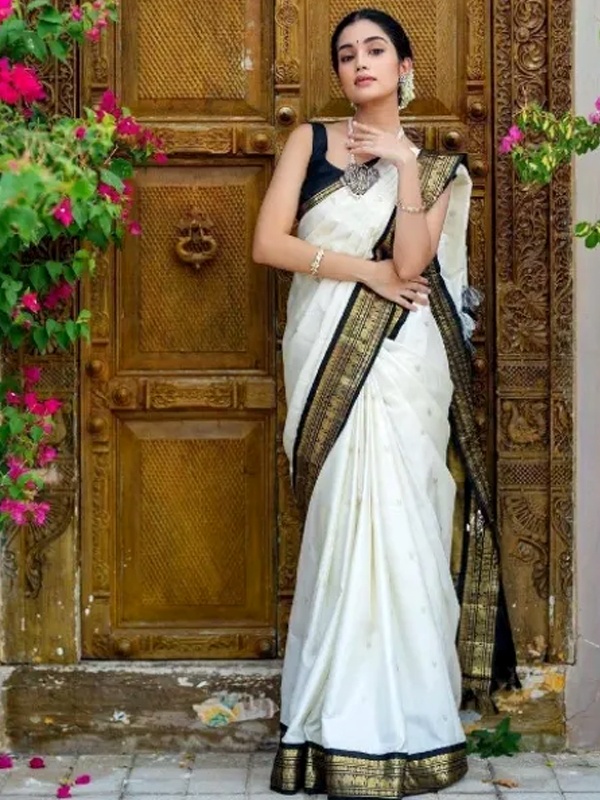Traditional white and black soft Banarasi silk saree with intricate woven patterns and black blouse