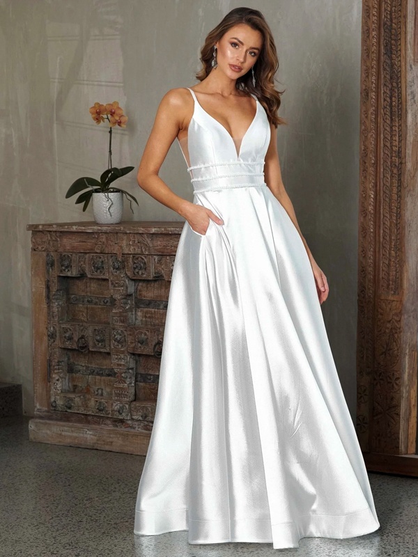 Woman wearing a pure white sleeveless A-line satin dress with a deep neckline, showcasing a simple yet elegant Christmas outfit.