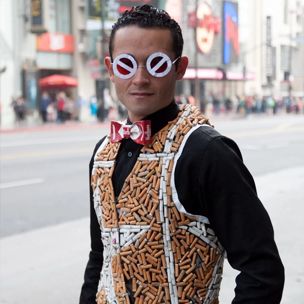 Eco-artist creates artistic vest garment from hundreds of discarded cigarettes collected in Hollywood demonstrating waste-to-fashion art Eco-artist creates artistic vest garment from hundreds of discarded cigarettes collected in Hollywood demonstrating waste-to-fashion art