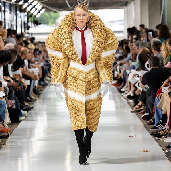 Chinese fashion designer Jiawei Han wearing innovative coat crafted entirely from recycled cigarette butts demonstrating sustainable design Chinese fashion designer Jiawei Han wearing innovative coat crafted entirely from recycled cigarette butts demonstrating sustainable design