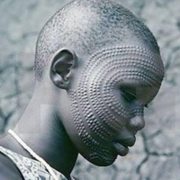 African tribal body scarification art with scratching and etching creating permanent decorative skin designs African tribal body scarification art with scratching and etching creating permanent decorative skin designs