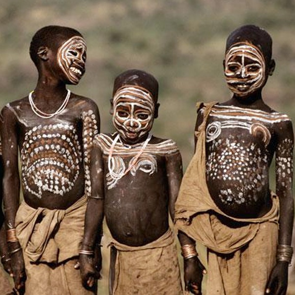 Traditional tribal body painting using natural clay, wood powder and colored plant pigments for ceremonial decoration Traditional tribal body painting using natural clay, wood powder and colored plant pigments for ceremonial decoration