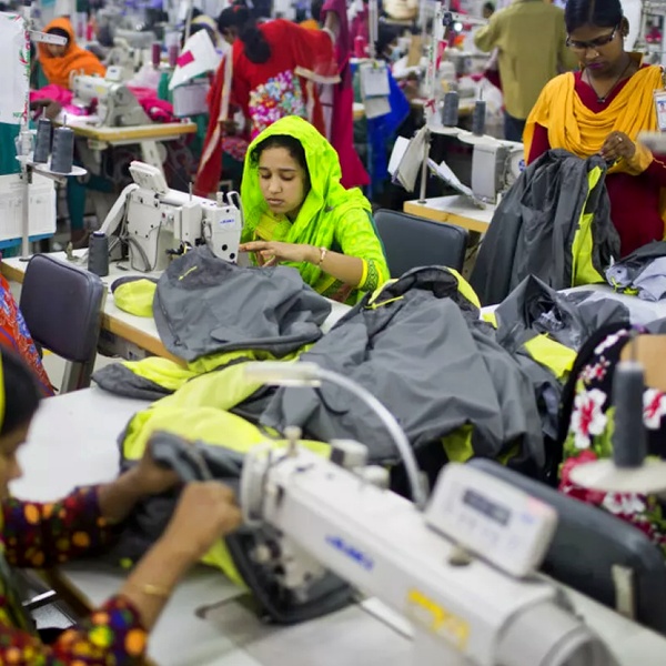 Garment workers in sweatshop conditions showing long hours, poor wages and unsafe working environments in textile factories Garment workers in sweatshop conditions showing long hours, poor wages and unsafe working environments in textile factories