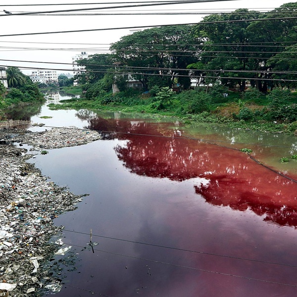 Water pollution from textile dyeing showing contaminated rivers and toxic chemicals from garment manufacturing processes Water pollution from textile dyeing showing contaminated rivers and toxic chemicals from garment manufacturing processes