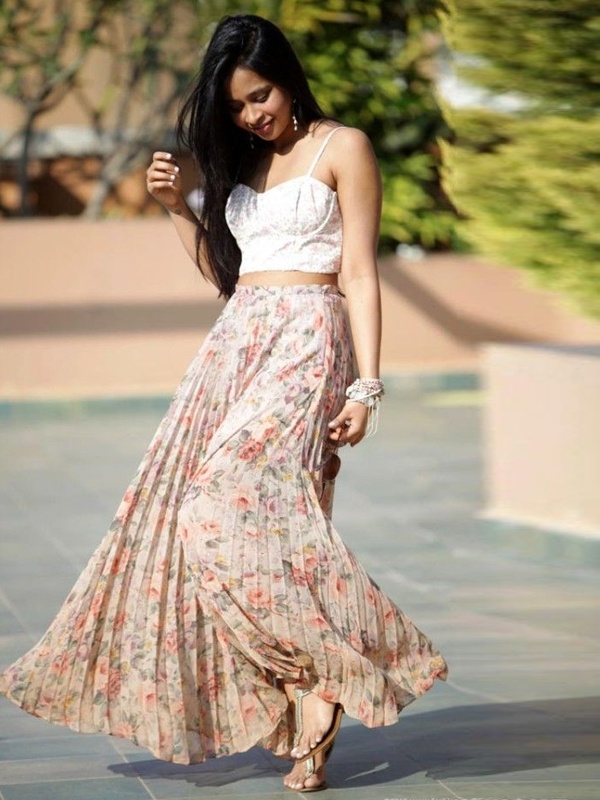 Beige pleated floral print maxi skirt with white sweetheart bralette showing midriff for trendy boho style
