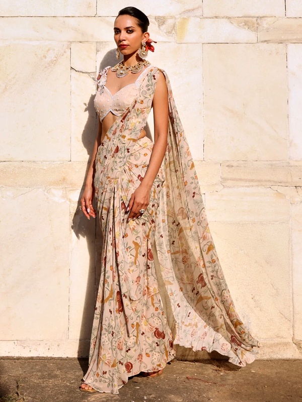 Light brown chiffon saree with small pink and cream floral print in sheer drape for elegant ethnic wear
