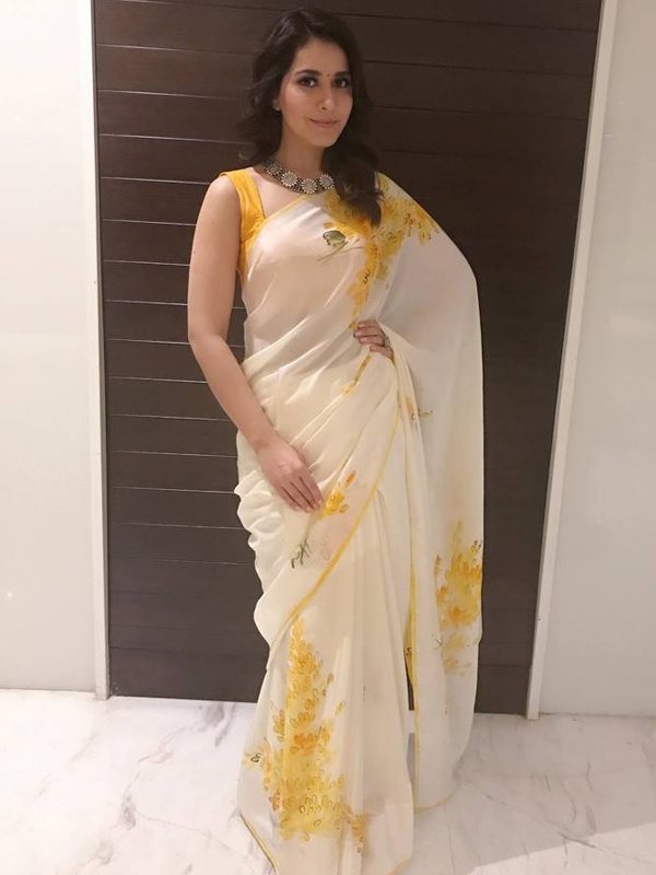 Raashi Khanna draped in white saree with yellow floral print design for traditional Indian fashion