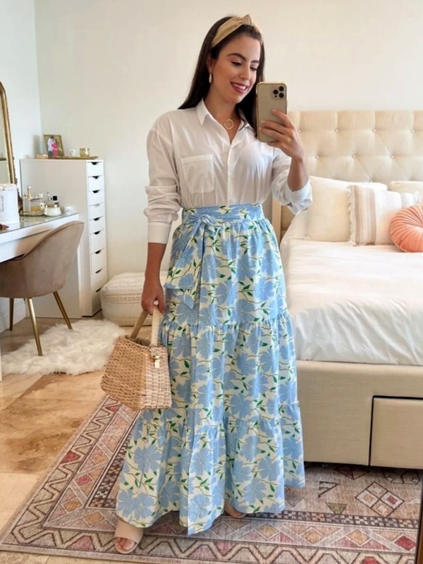 Sky blue floral print maxi skirt with bow waist detail paired with white shirt and beige mules for feminine style