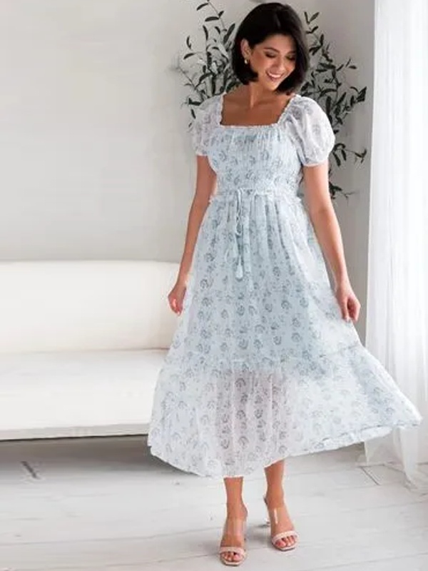 White floral midi dress with puff sleeves and smocked ruffle waist featuring pastel blooms for romantic style
