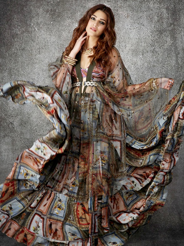 Kriti Sanon in hippie boho look wearing sheer Hututi print cape, tiered flowing skirt, dramatic desi jewelry and traditional juttis blending Indian bohemian style Kriti Sanon in hippie boho look wearing sheer Hututi print cape, tiered flowing skirt, dramatic desi jewelry and traditional juttis blending Indian bohemian style