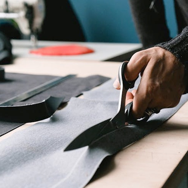 Fashion garment construction showing fabric cutting, sewing techniques and professional clothing manufacturing process Fashion garment construction showing fabric cutting, sewing techniques and professional clothing manufacturing process