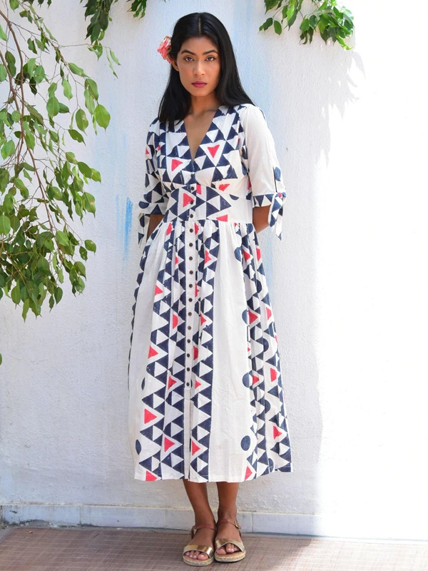 White dress with geometric motifs showing lines diamonds and traditional Indian patterns