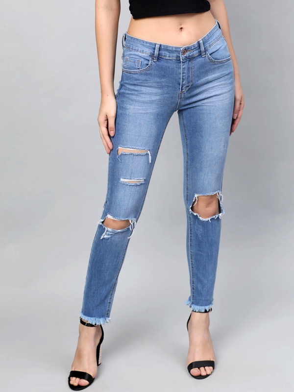 Distressed ripped jeans with intentional tears, frays and worn patches for edgy look