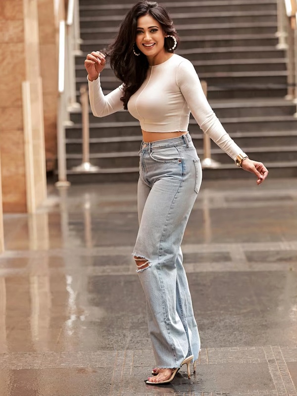 Bollywood actress Shweta Tiwari in white crop top with high-waisted ripped jeans and high heels striking confident pose