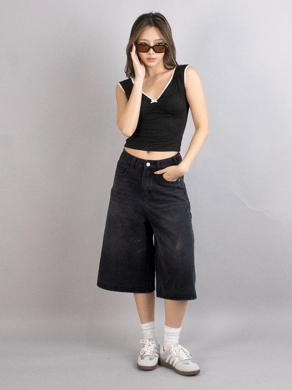 Woman wearing black high-waisted bermuda jorts - versatile minimalist casual fashion