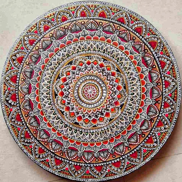 Traditional mandala art with colorful circular symmetrical patterns radiating from center point Traditional mandala art with colorful circular symmetrical patterns radiating from center point