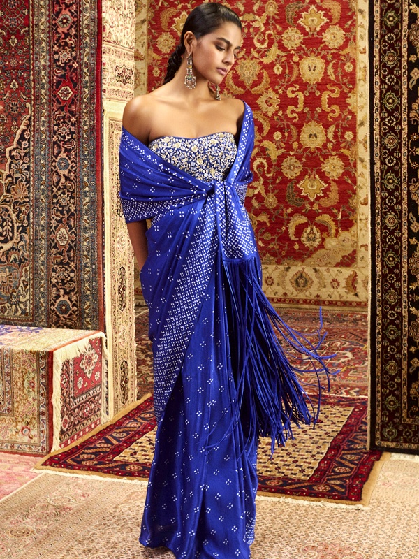 Anita Dongre royal blue pre-draped bandhani saree with long fringes and a strapless embroidered bustier. Anita Dongre royal blue pre-draped bandhani saree with long fringes and a strapless embroidered bustier.