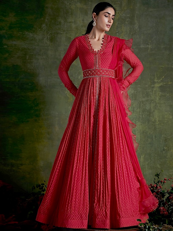 Hibiscus red chanderi anarkali with varied embroidery, attached belt and a matching ruffled dupatta. Hibiscus red chanderi anarkali with varied embroidery, attached belt and a matching ruffled dupatta.