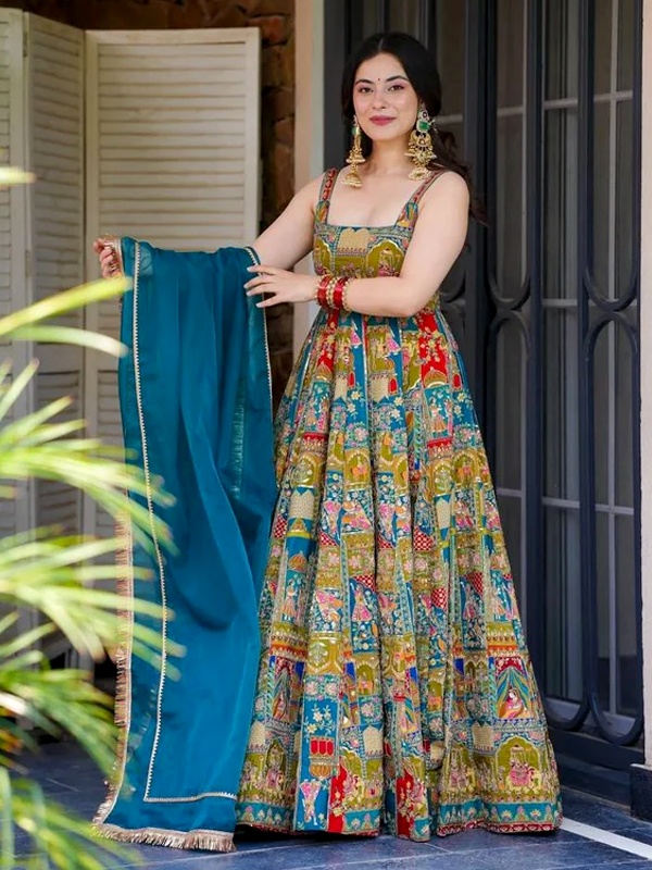 Multi-coloured digital printed organza silk Anarkali gown paired with a teal blue georgette dupatta. Multi-coloured digital printed organza silk Anarkali gown paired with a teal blue georgette dupatta.