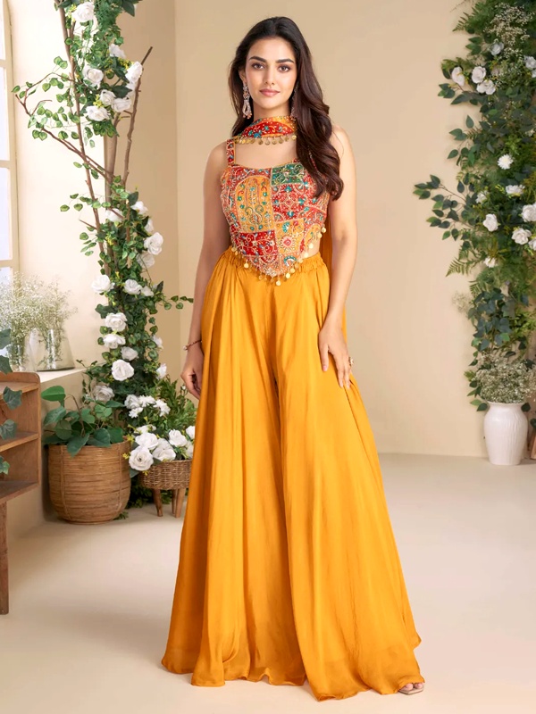 Mustard yellow sharara set featuring a multi-colored embroidered bustier top with coin detailing and wide-leg pants. Mustard yellow sharara set featuring a multi-colored embroidered bustier top with coin detailing and wide-leg pants.