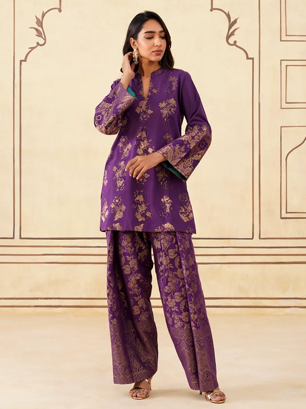 Wine brocade Farshi set with dull gold floral zari woven motifs and wide-leg pants. Wine brocade Farshi set with dull gold floral zari woven motifs and wide-leg pants.