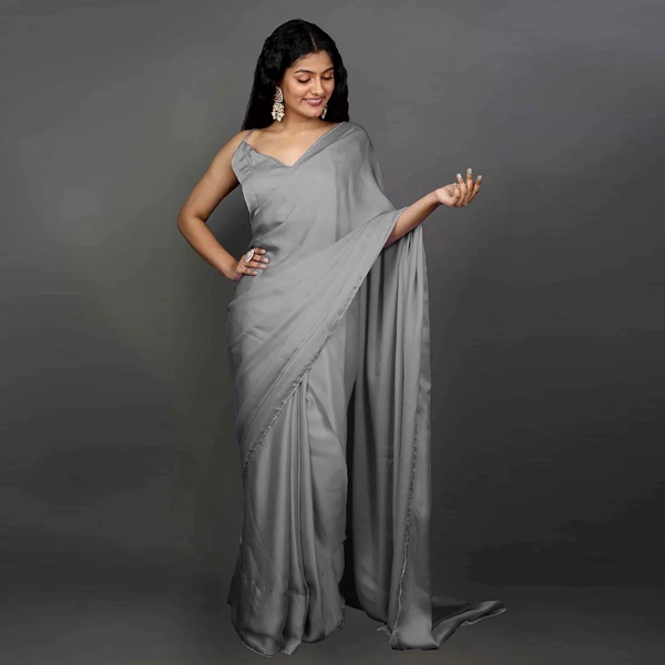 Woman wearing a monochrome grey saree showing drape and tone on tone styling