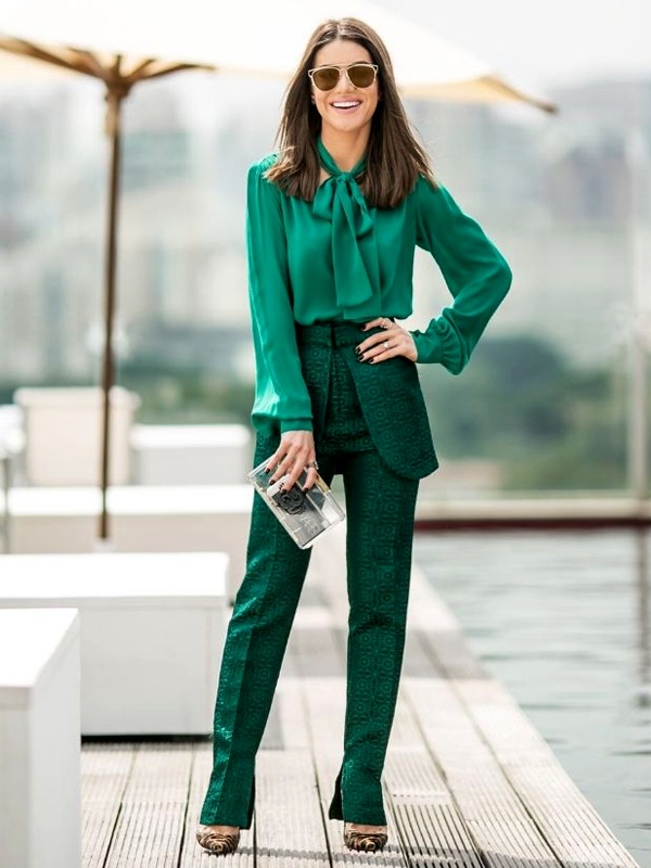 Woman wearing emerald green pussy bow blouse with textured high waisted trousers