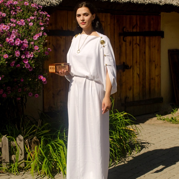 Woman in white Greek style linen chiton demonstrating monochrome white dressing
