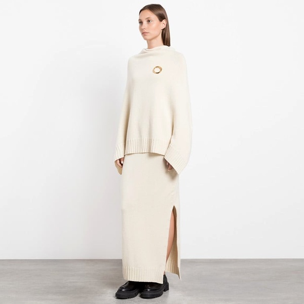 Jil Sander style ivory ensemble showing subtle strength in monochrome dressing