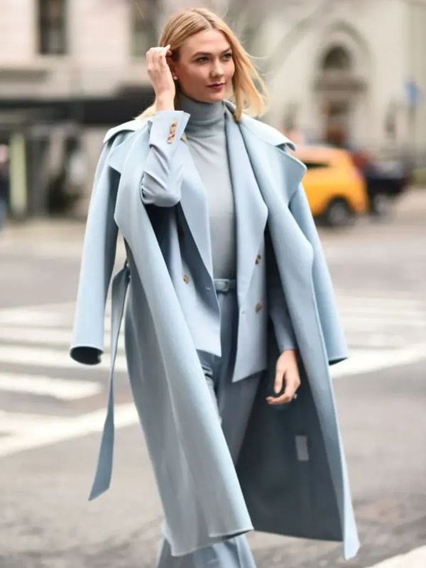 Karlie Kloss wearing layered powder blue outfit with turtleneck blazer and long coat