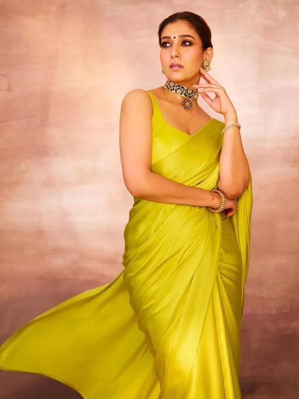 Nayanthara wearing lime yellow satin saree with sleeveless blouse and silver choker