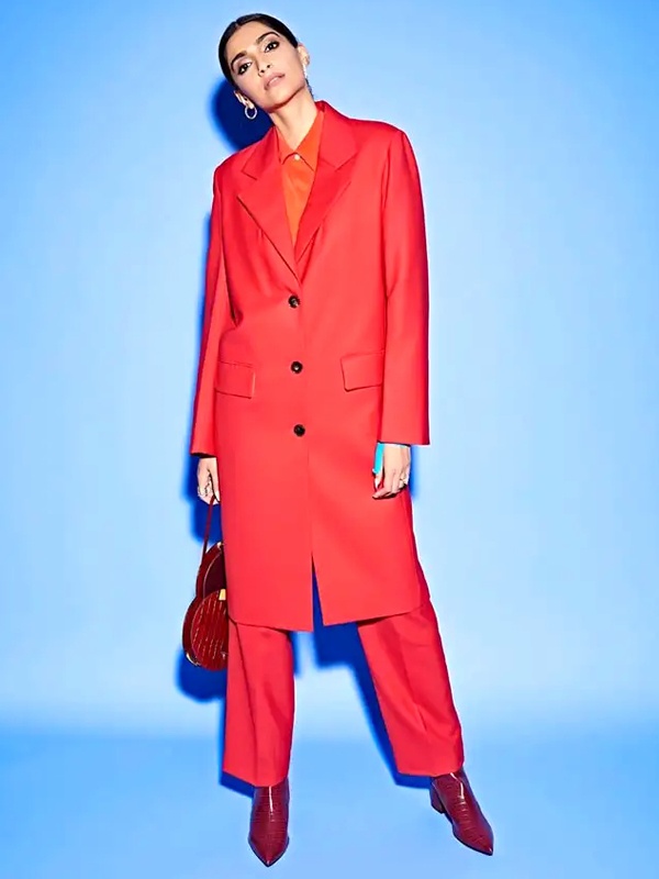 Sonam Kapoor wearing coral red oversized longline blazer with wide leg trousers