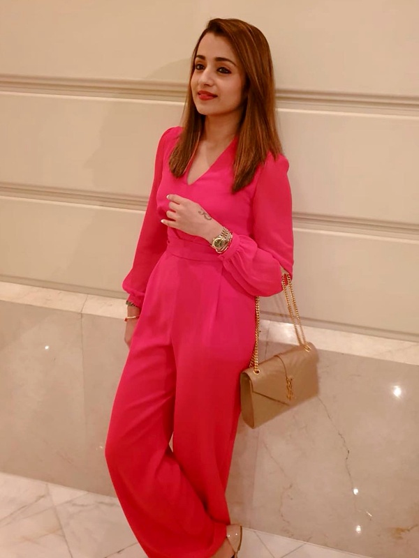 Trisha Krishnan wearing fuchsia pink jumpsuit with bishop sleeves and wide leg trousers