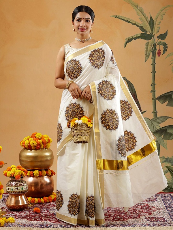 Woman in a cream saree with intricate peacock feather embroidery and a gold border, holding a basket of flowers. Woman in a cream saree with intricate peacock feather embroidery and a gold border, holding a basket of flowers.