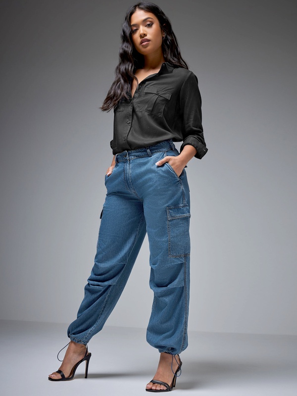 Dressy denim parachute trousers styled with black button-up shirt tucked in and black strappy heels for elevated campus fashion