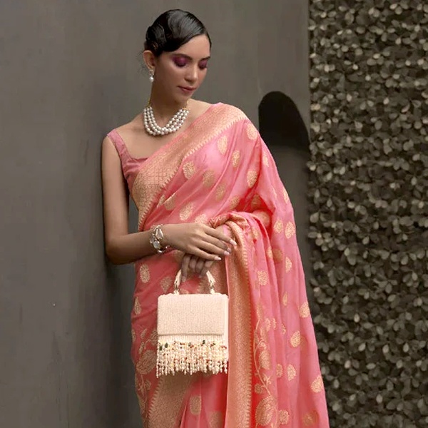 Classic pearl necklace paired with pink saree for elegant and sophisticated jewelry styling