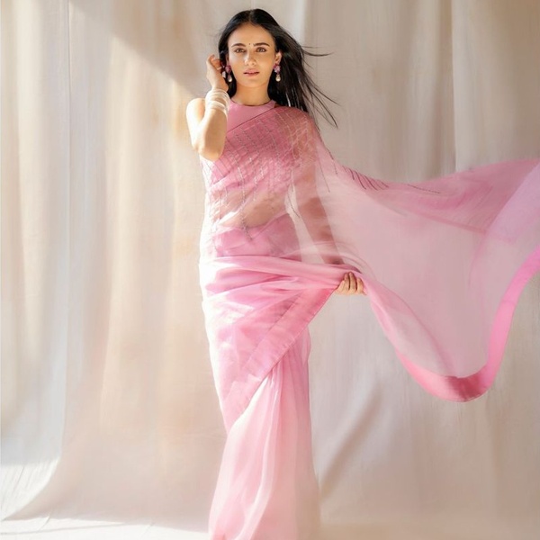 Bollywood celebrity in pink saree showcasing elegant minimal styling for red carpet