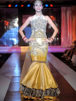 Ritu Beri's Bridal Collection exudes regal charm with its intricate silver embellishments and a striking gold mermaid silhouette.