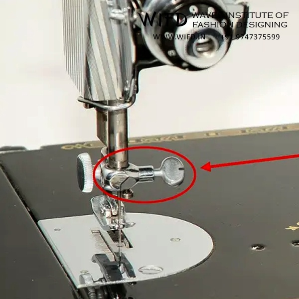 Needle clamp and screw holding needle firmly in place on needle bar