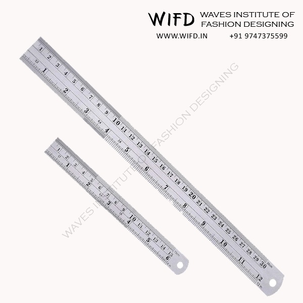 Tailor's straight ruler or scale made of wood, metal or plastic with clear inch and centimeter markings