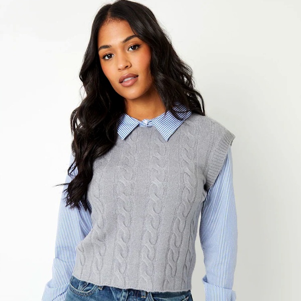 Soft neutral color palette pairing grey ribbed knit vest with light blue oxford shirt for calm sophisticated look