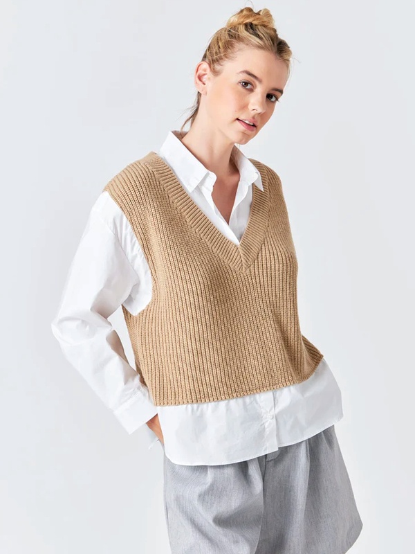 Casual summer outfit white long-sleeve shirt under light brown deep V-neck sleeveless sweater vest paired with grey tailored shorts