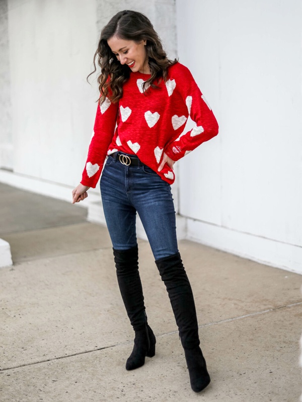 Trendy red heart sweater with distressed print styled with dark denim and thigh-high boots