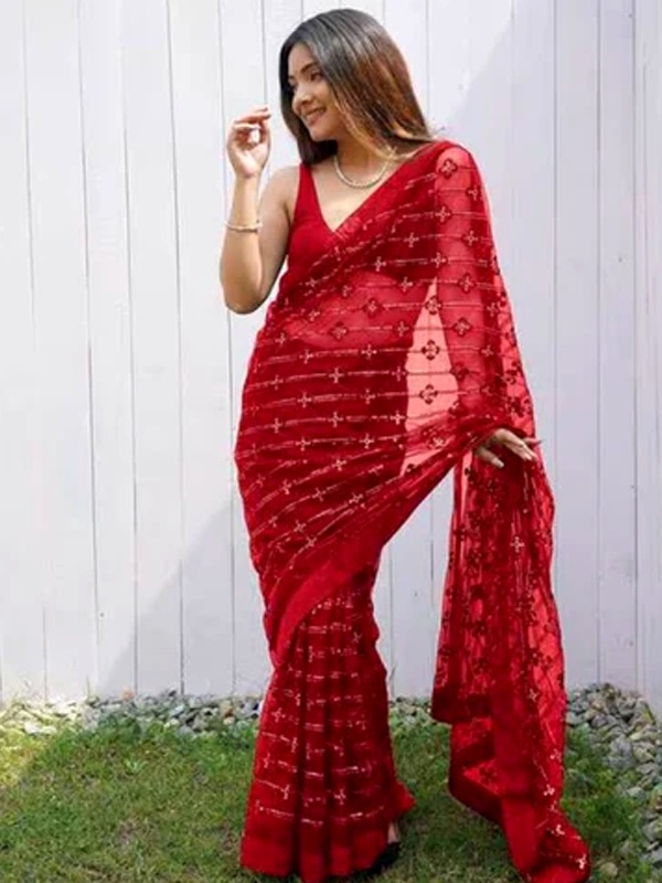Modern red net saree with embellishments and deep neck sleeveless blouse for Valentine's party